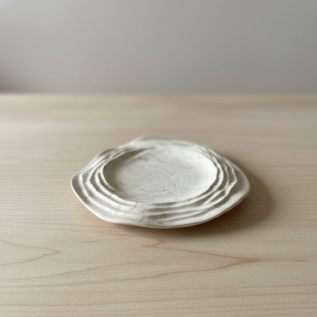 Beautiful handmade ceramic dish with textured surface against a neutral background